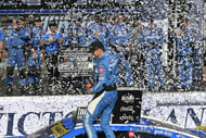 Denny Hamlin (11) celebrates with his team after winning the Enjoy Illinois 300. Source: Imagn